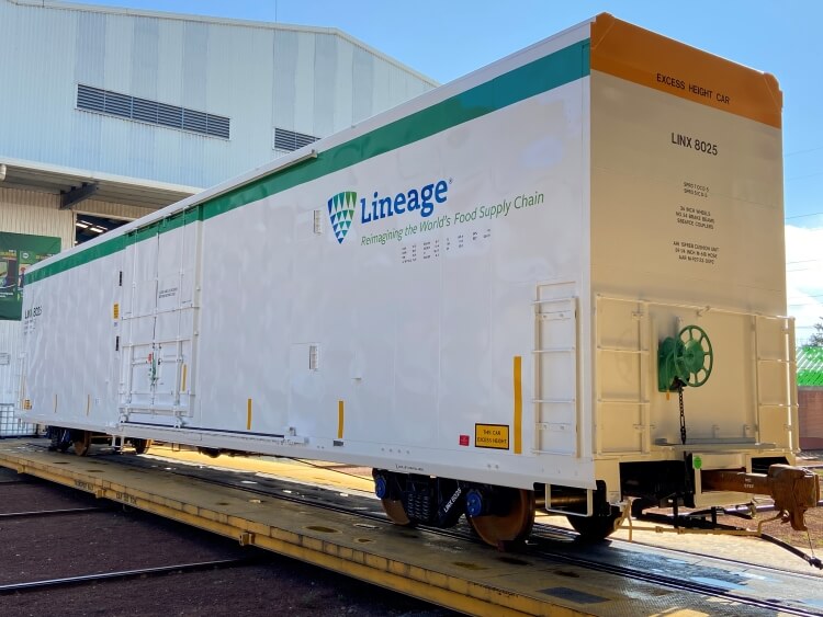 A Lineage branded refrigerated railcar on tracks, showcasing their sustainable rail solutions for long-distance food transportation as part of the cold chain logistics.